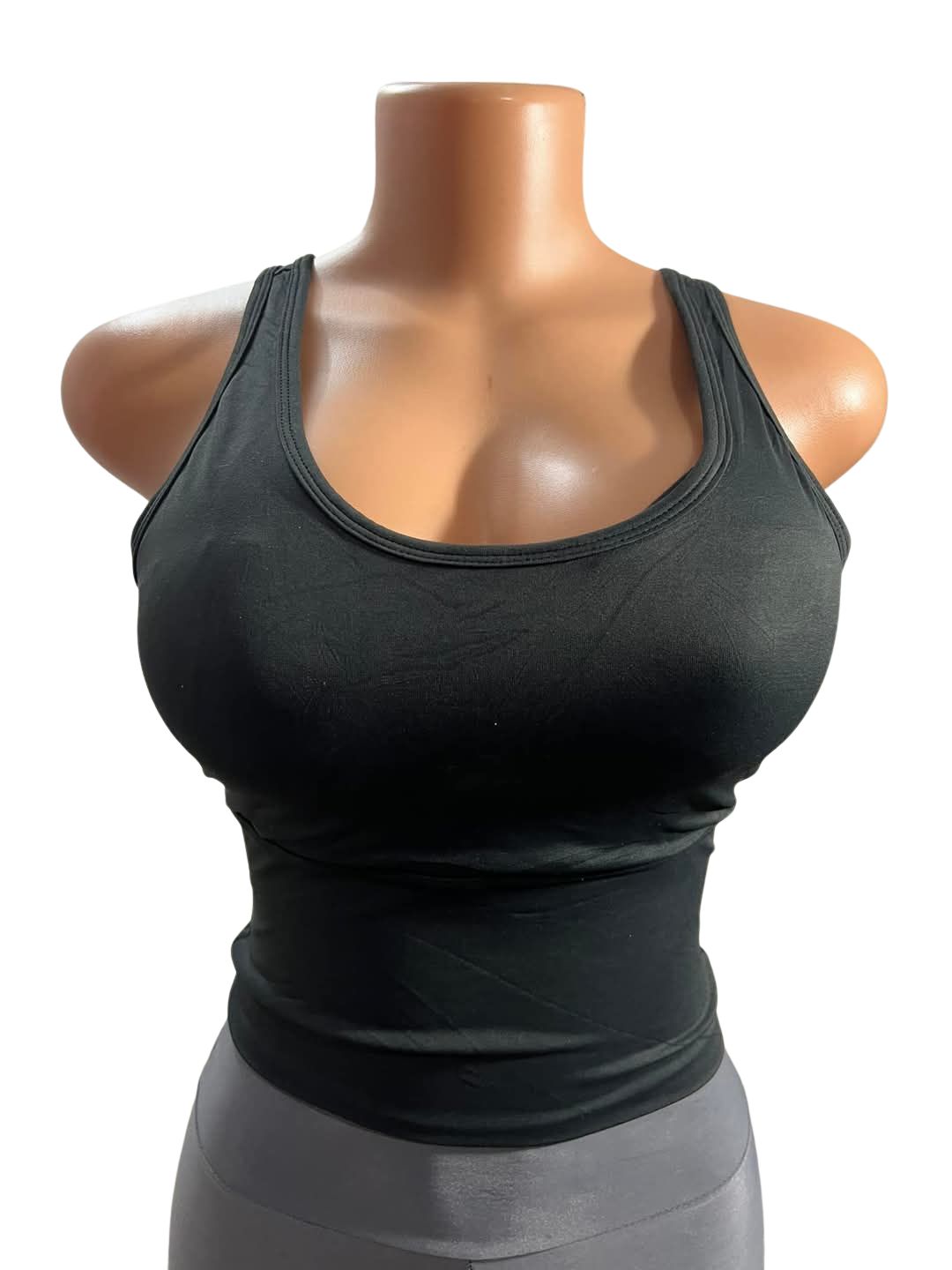 Front view of mannequin wearing black padded bralette with intricate crisscross strap design