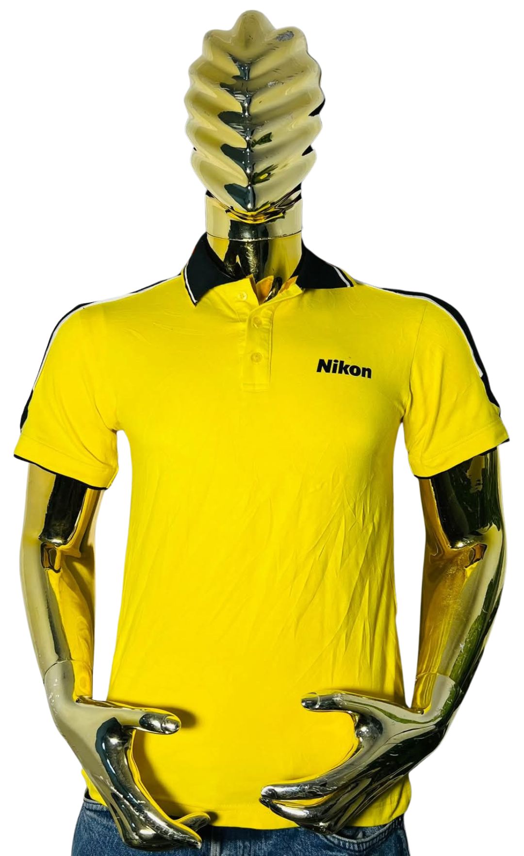 Mannequin wearing bright yellow short-sleeved polo shirt with Nikon logo on chest and black shoulder/collar accents; designed for chest 42–44 inches and neck 16–17 inches (size Large)