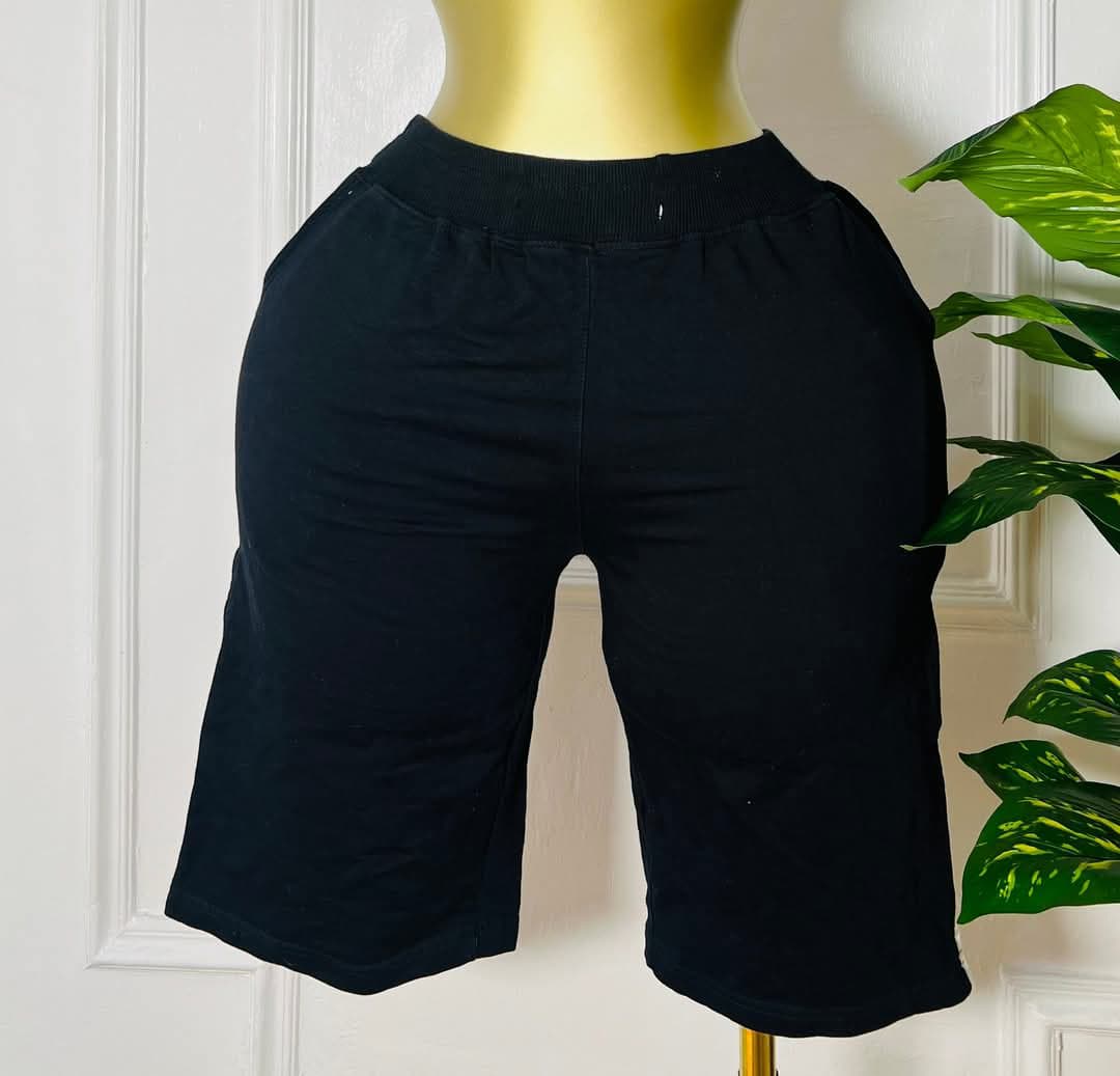 FlowFlex™ black knee-length lounge shorts with elastic waistband and minimalist cut, fits sizes small to large