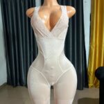 Beige full-body shapewear bodysuit with lace-trimmed thigh openings and adjustable shoulder straps for large frames—features smooth sculpting front panel for tummy control and bust support (38–40” bust, 32–34” waist, 42–44” hips)."