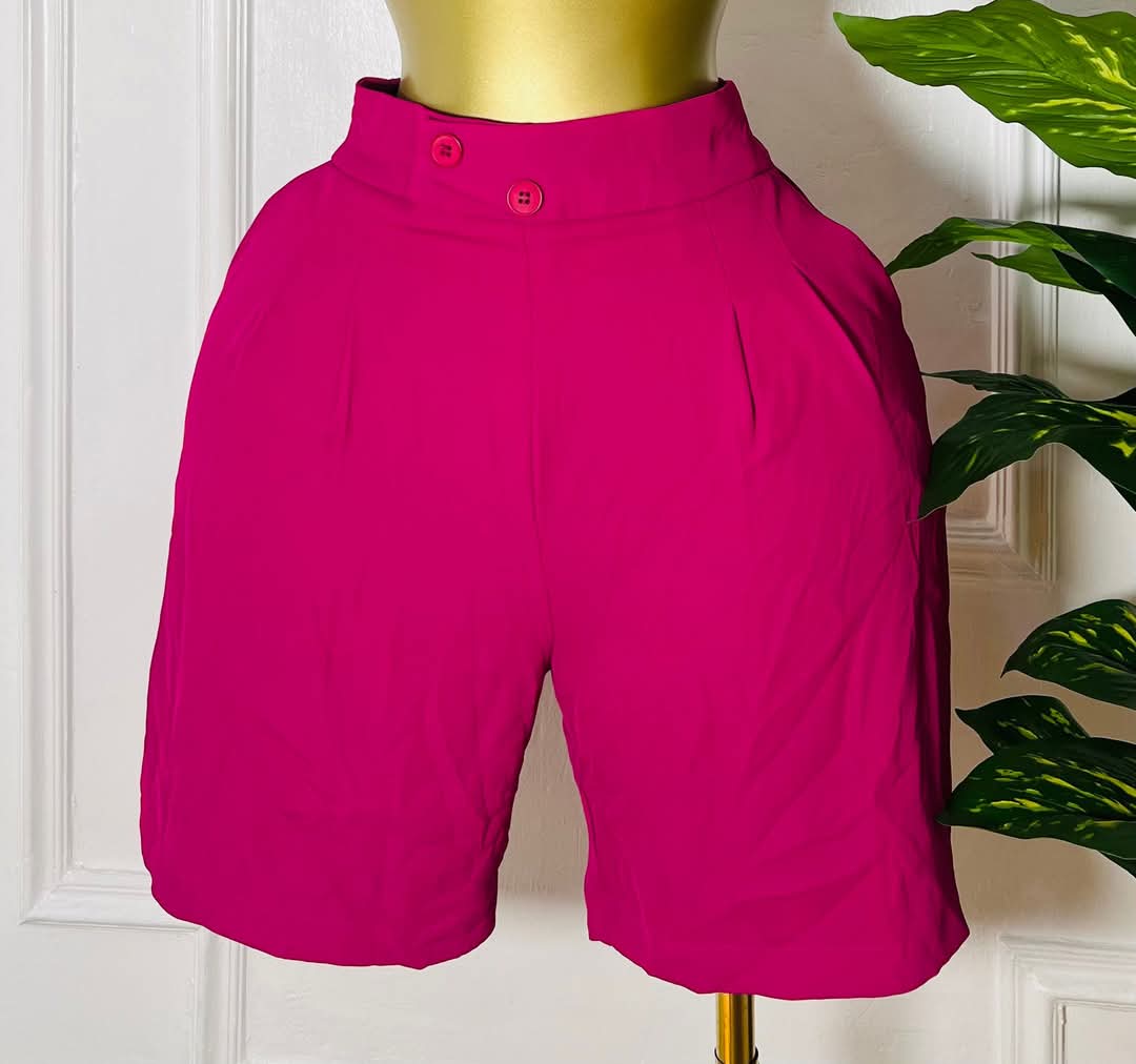 Women's fuchsia high-waist tailored shorts with front pleats.